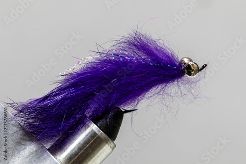 Purple leach fly on a tying vice ready to take fishing for steelhead