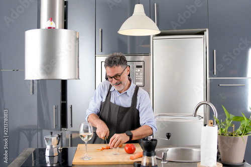 Mature man prepare meal in modern home kitchen