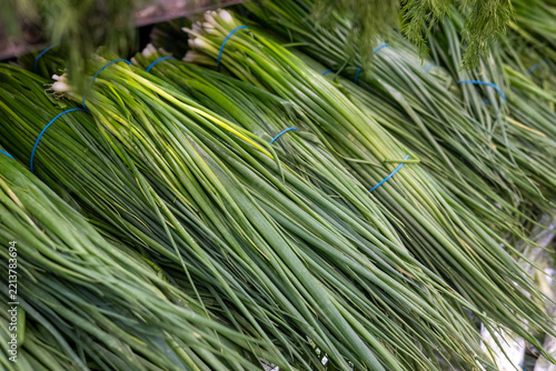 Fresh green onion bundles at a seasonal farmers market