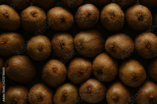 Close-up of ripe kiwi fruit pattern in low-key light