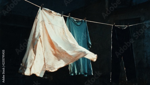 Laundry drying on clothesline in warm sunlight at home