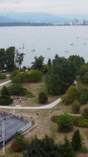 Vertical aerial sweep over waterfront park and bay