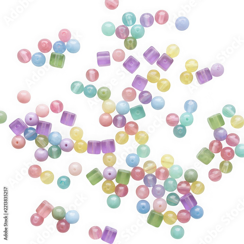 Assorted colorful translucent plastic beads scattered on a transparent background