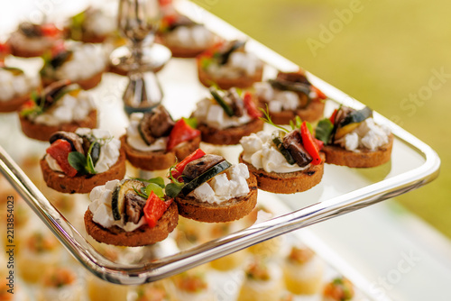 Crostini appetizers with cream cheese and grilled vegetables