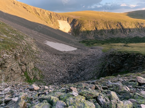 Mountain landscape with scree slope and snow patches