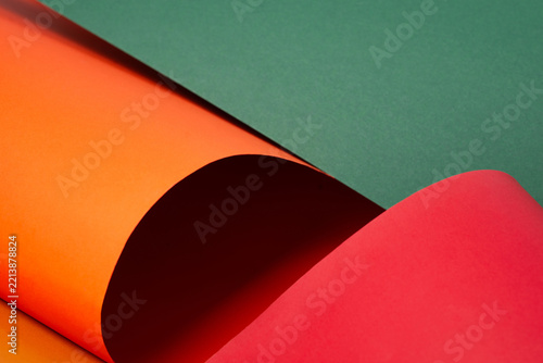 Abstract background of curved colored papers in orange, green and red colors