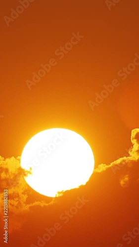 Time lapse of the sun rising behind clouds in Florida. Vertical Video.