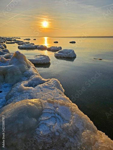 Ice hummocks on the shore at sunset