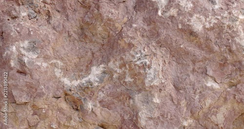 Slow Slider Across Weathered Pink Rock Texture with White Mineral Deposits