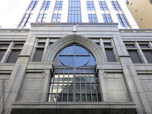 Classic stone facade with an arched window of a prestigious office building in Tokyo.