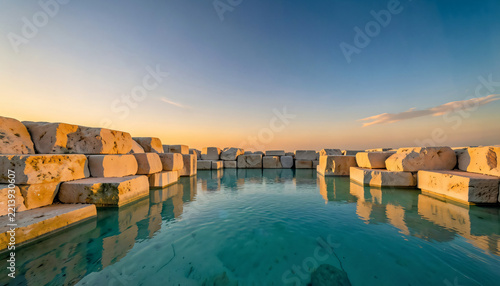 Geometric sandstone block pedestals in warm desert environment, luxury perfume bottle mockup background.