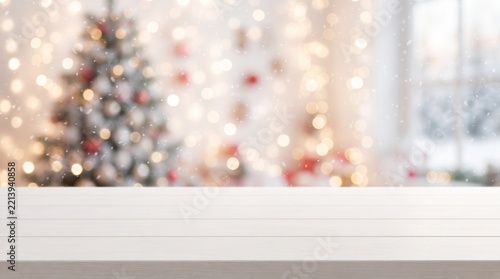 Empty white wooden table top with abstract muted blur christmas tree and snow fall background with bokeh light,Holiday backdrop,Mock up banner for display or montage of product