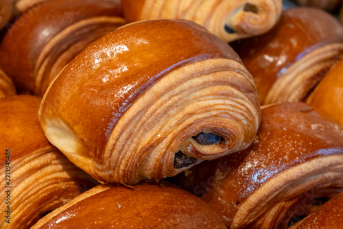 French pastry roll pain au chocolat for traditional breakfast, fresh baked in artinasal bakery in Paris, France