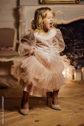 Young girl playfully posing in elegant room setting
