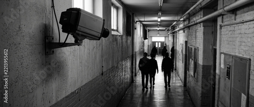 Surveillance Camera Monitors People Walking Down Dark Grungy Hallway Security Monitoring Concept