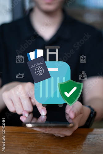 Person using laptop searching for travel insurance passport flight health protection holiday trip journey trip risk coverage concept