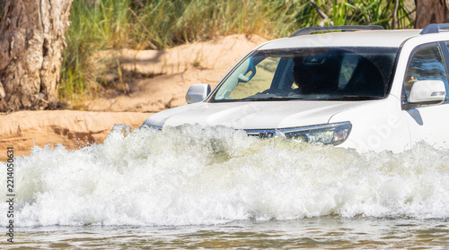 4x4 vehicle driving through or across river on expedition  in Western Australian outback