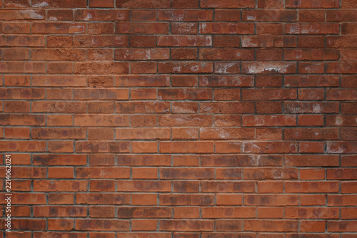 Close-up view of an old brick wall with visible texture and color variations