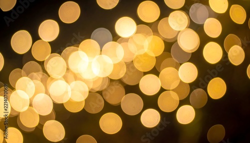 Floating golden dust particles with soft light orbs and shimmering bokeh glares isolated on dark background for texture