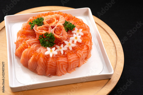 Salmon sushi styled to resemble a cake—a dish designed as a birthday gift. Use rice hidden inside instead of cake or bread. Japanese food.