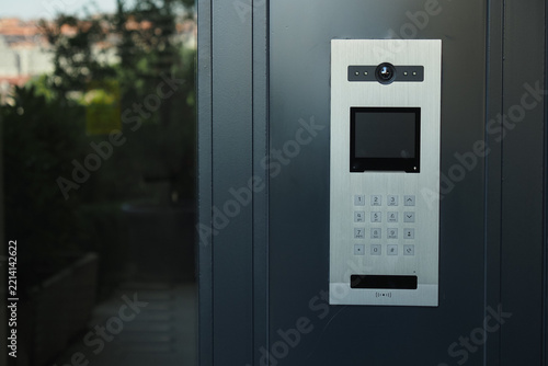 Door intercom system located outside a building entrance with number pad