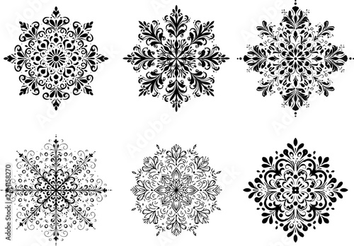 Set of ornate black floral snowflake symbols for elegant winter and Christmas decorative design projects