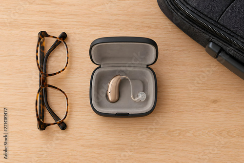 Hearing Aid in Travel Case with Glasses and Luggage