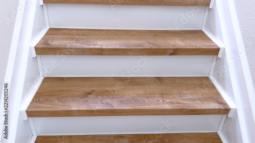 Close view of wooden stairs with white risers