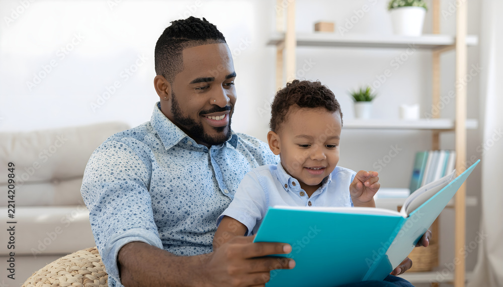 Fototapeta premium Father and son reading together at home, capturing family bonding, childhood literacy, positive parenting, education and warm everyday moments.