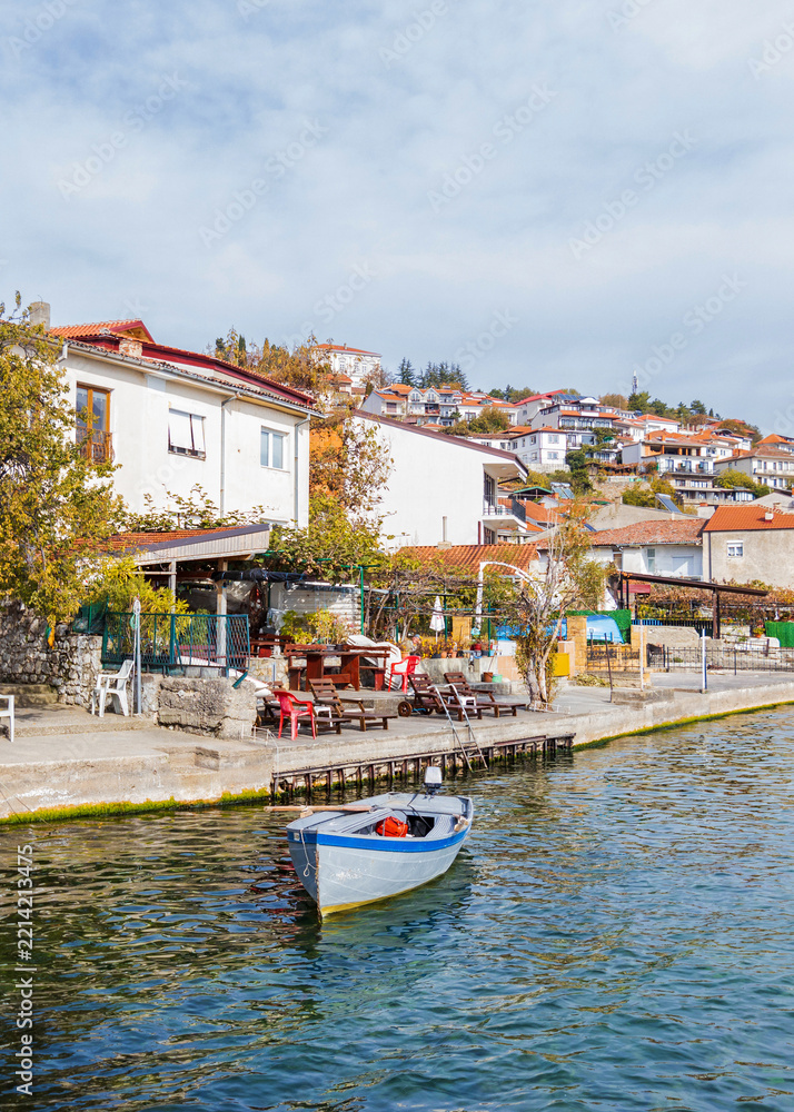 Fototapeta premium Quiet lakeside terrace with a moored boat in Ohrid old town