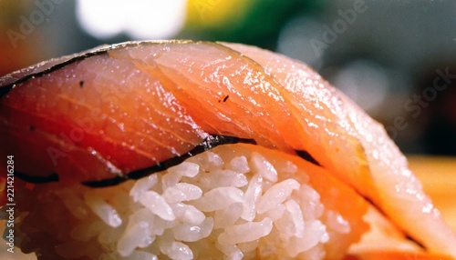 Fresh traditional Japanese nigiri sushi set served on dark ceramic plate in authentic restaurant