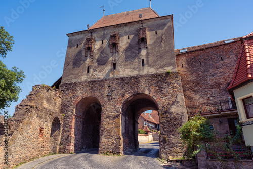 Medieval fortified gateway with twin arches and massive stone walls in Sighisoara Romania