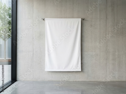 Blank white fabric banner hanging on a modern concrete wall for mockup
