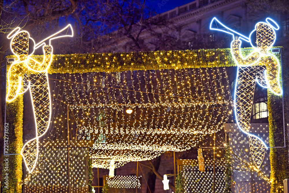 Fototapeta premium Illuminated Christmas Angel Light Installations at Vienna City Hall Square Market