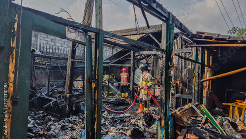 Indonesian firefighters are carrying out cooling-down operations at a building that was gutted by fire