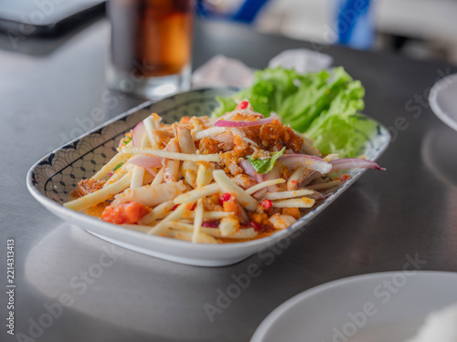 Spicy Thai young coconut shoot salad with fresh crab meat and crab egg served on a plate