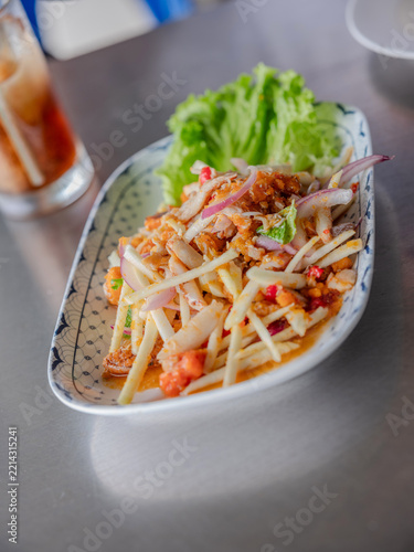 Spicy Thai young coconut shoot salad with fresh crab meat and crab egg served on a plate