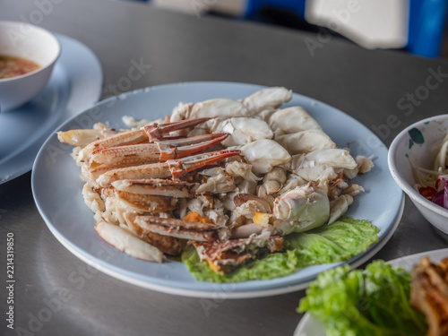 Steamed crab meat and crab claws served on a plate with dipping sauce
