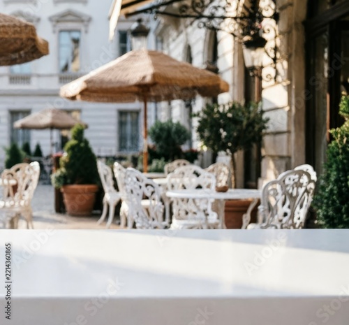 Elegant Outdoor Cafe Terrace With White Furniture And Parasols For Hospitality Marketing