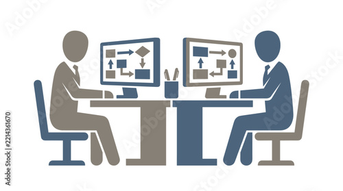 Two colleagues sitting at desks working on computers with flowcharts