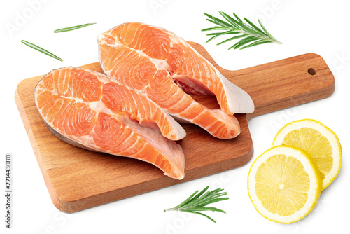 slices of raw fish, salmon, trout, steak, on wooden board isolated on white background, clipping path