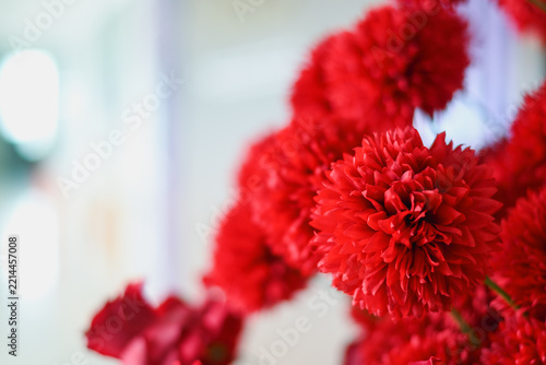 Vibrant red pom-pom artificial flowers against a soft background