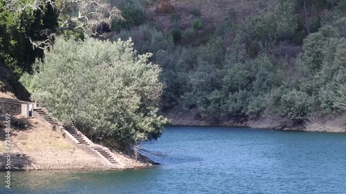 Zêzere river flowing through a tranquil natural landscape in portugal