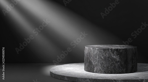 Dark, cylindrical marble platform illuminated by a spotlight