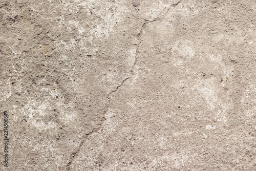 Obraz na plátně Close up view of a light gray weathered concrete floor showing a vertical hairline crack, fine grain texture, and subtle white dust marks ideal for design work