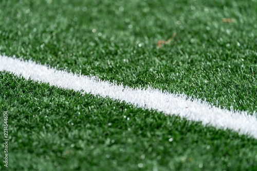 White line marker across a green artificial turf field