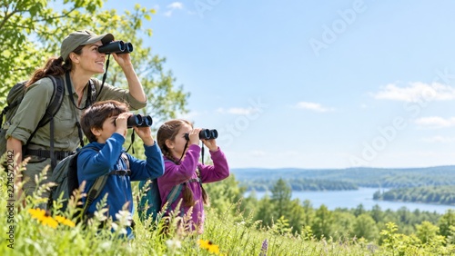 Teacher and Children Exploring a Wildflower Meadow with Binoculars