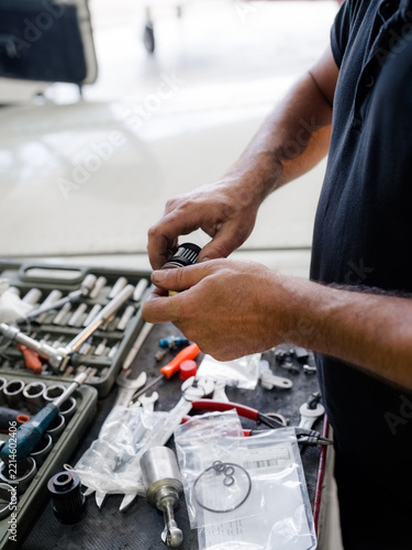 Mechanic assembling engine parts