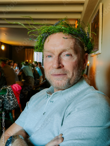 Portrait of a man at a solstice event wearing a flower crown