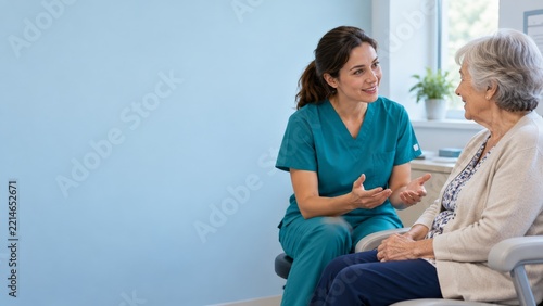 Smiling nurse talking with a senior woman in a softly lit clinic